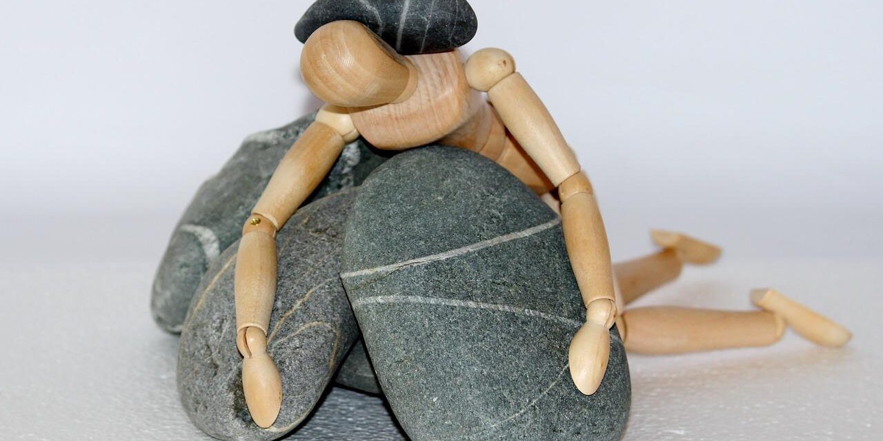 wooden figure, stones, struggle for life-980784.jpg